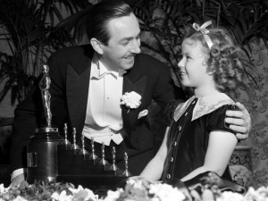 Shirley Temple showing Mr. Walt Disney his 7 Oscars in honor of Snow White