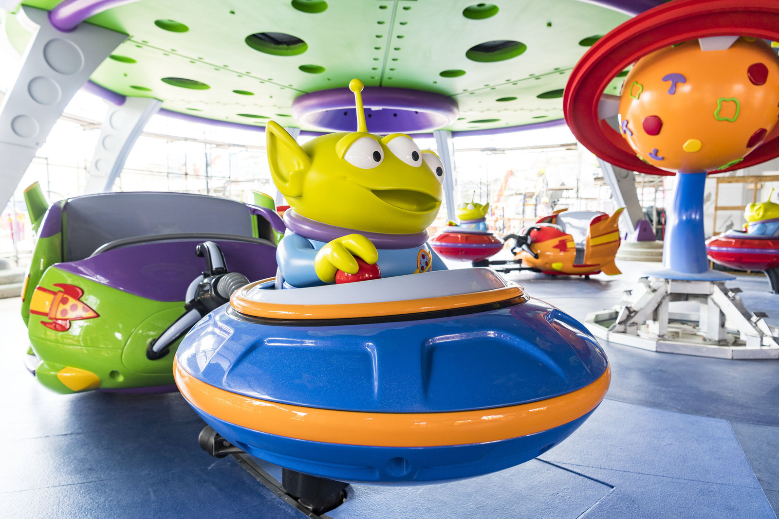 Little green aliens from the hit DisneyPixar "Toy Story" films pilot toy rocket ships in the Alien Swirling Saucers attraction that will be part of the new Toy Story Land